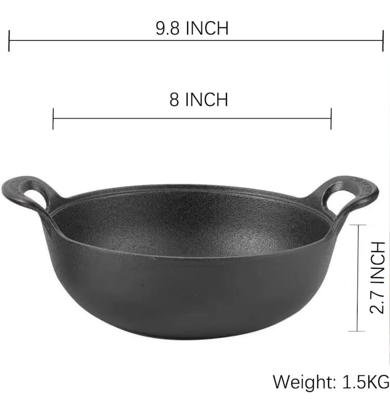 May include: A black cast iron pan with two loop handles. The pan is 9.8 inches wide, 8 inches in diameter, and 2.7 inches deep. It weighs 1.5 kg.
