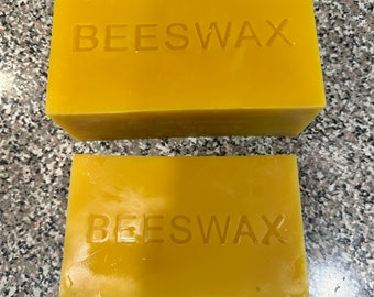 May include: Two blocks of beeswax, one larger than the other, both with the word "BEESWAX" embossed on the top.