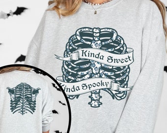 May include: A gray sweatshirt with a floral ribcage design and the text "Kinda Sweet Kinda Spooky".