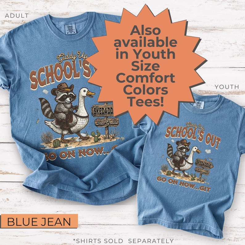 May include: Blue jean-colored t-shirts with a graphic featuring a raccoon riding a goose, cowboy hat, and text that reads "Giddy Up SCHOOL'S" and "SCHOOL'S OUT". The shirts are available in adult and youth sizes.