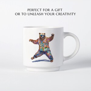 May include: White ceramic mug featuring a colourful illustration of a bear wearing sunglasses and a patterned shirt. The bear is dancing with its arms outstretched. The mug has a handle on the right side.