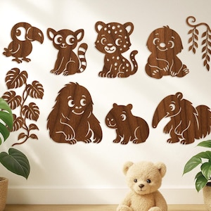 May include: Wooden animal wall decor featuring a toucan, lemur, leopard, dog, and other creatures. The brown cutouts are arranged on a white wall with decorative leaves and a teddy bear. A charming addition to a nursery or playroom.
