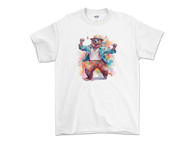 May include: White t-shirt featuring a watercolour illustration of a bear wearing a hat and a plaid shirt, dancing with its arms raised.
