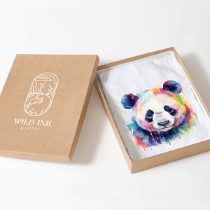 May include: A white t-shirt with a colorful watercolor panda print in a brown cardboard box. The box has the logo "WILD INK DIGITAL" printed on the side.