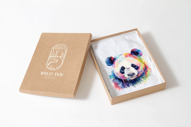 May include: A white t-shirt with a colorful watercolor panda print in a brown cardboard box. The box has the logo "WILD INK DIGITAL" printed on the side.