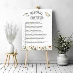 Puede incluir: Un cartel de bienvenida para un baby shower con un diseño de pato verde y blanco. El cartel dice "Bienvenido, Gracias por ayudarnos a bendecir este nido, Baby Shower de Elizabeth 6-27-2023". El cartel tiene una lista de tareas para que los invitados ayuden en la ducha.