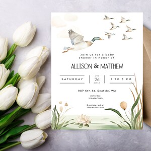 May include: A baby shower invitation with a watercolor illustration of ducks flying over a pond with green reeds. The invitation is for Allison & Matthew on Saturday, July 26th, 20XX from 1 to 3 PM. The address is 987 6th St, Seattle, WA. The phone number is 123-456-7890. The invitation says "Registered at Amazon.com".