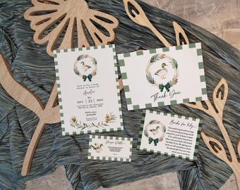 May include: Green and white checkered baby shower invitation with a watercolor illustration of a duck in a wreath. The invitation says "Join us for a baby shower in honor of Amelia" and includes the date, time, and location. There is also a thank you card with the same design and a card that says "Books for baby".