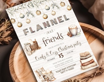 May include: A Christmas party invitation with a white wood background and a watercolor illustration of a cozy scene with a rocking chair, a basket of blankets, and a mug of hot chocolate. The text reads "Flannel and friends - You're invited to a Comfy & Cozy Christmas party - December 15 - 5:00 PM".
