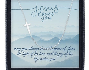May include: A silver necklace with a small cross pendant in a blue box with the text "Jesus loves you" and a message about peace, love, and joy.