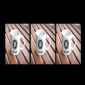 May include: Three white coffee mugs with black illustrations and text. The mugs read "I am calm!" "I'm not angry!" and "I need coffee!"