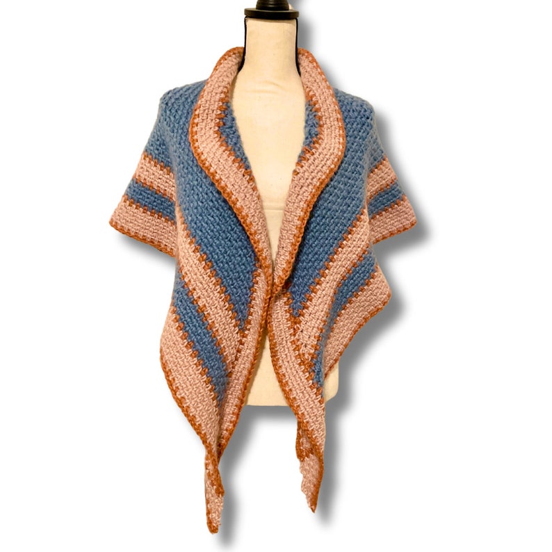 May include: A blue and pink striped crochet shawl with a fringe on the bottom edge.
