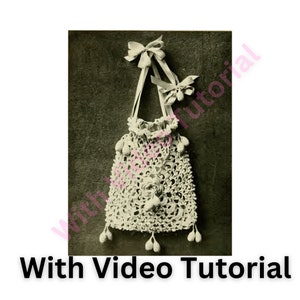 May include: A white crocheted drawstring bag with a scalloped top and a bow on the top. The bag has a crocheted tassel on the bottom and is hanging from a white ribbon.