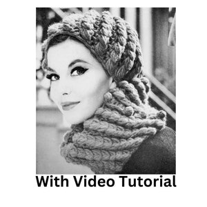 May include: A black and white photo of a woman wearing a chunky knit hat and matching scarf. The hat and scarf are made with a textured stitch that creates a unique and stylish look. The text "With Video Tutorial" is printed below the image.
