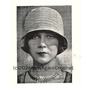 May include: Black and white photo of a woman wearing a crocheted hat. The hat has a wide brim and is made of a textured yarn. The woman is looking directly at the camera. The photo is from the 1920s and has a vintage feel.