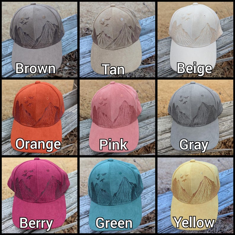 May include: Nine different colored baseball caps with an embroidered mountain scene and birds in flight. The colors are brown, tan, beige, orange, pink, gray, berry, green, and yellow.