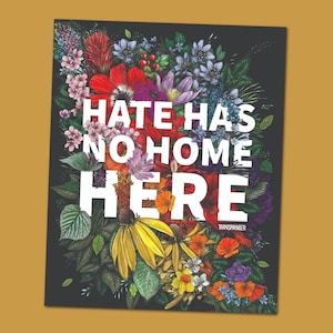 May include: A poster with a black background featuring a vibrant floral arrangement. The flowers, in shades of red, yellow, purple, and pink, surround the white text: "HATE HAS NO HOME HERE." The artist's name, "TRANSPAINTER," is at the bottom.