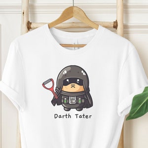 May include: White t-shirt with a cartoon image of Darth Vader holding a potato peeler. The text "Darth Tater" is printed below the image.