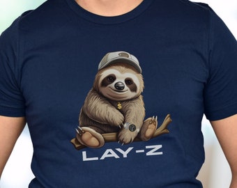 May include: A navy blue t-shirt with a cartoon sloth wearing a baseball cap and a gold chain. The sloth is sitting on a branch and the text "LAY-Z" is printed below it.