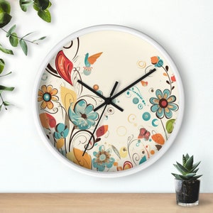 May include: White round clock with a floral design featuring blue, yellow, red, and orange flowers. The clock has black hands and a white background.