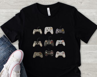 May include: A black t-shirt with a design of nine different video game controllers in various colors and styles.