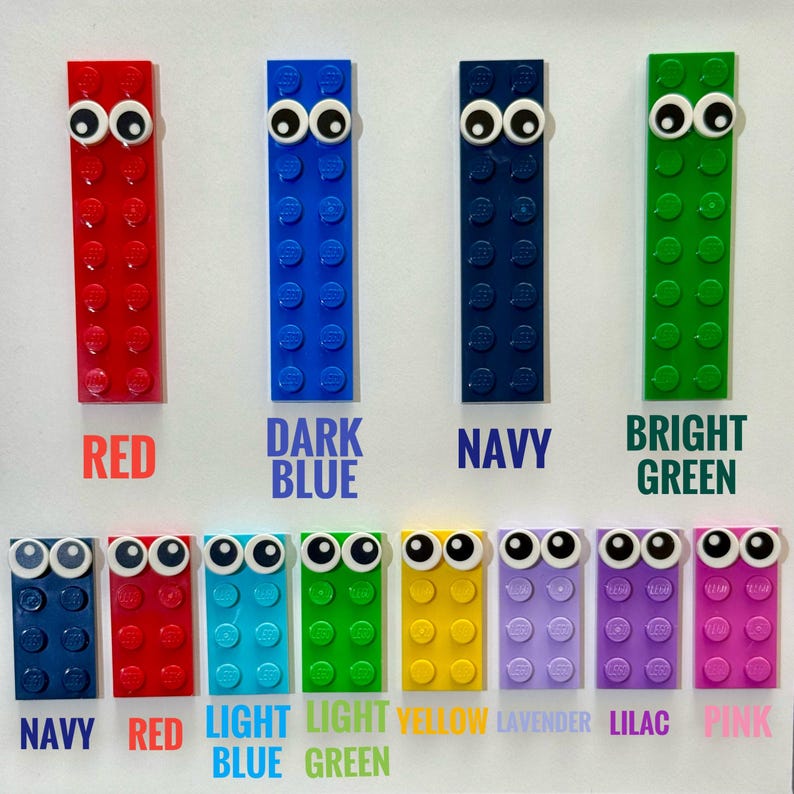 May include: A set of ten colorful Lego bricks with googly eyes. The bricks are arranged in two rows of five. The colors are red, dark blue, navy, bright green, navy, red, light blue, light green, yellow, lavender, lilac, and pink.