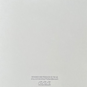 May include: White card with black text that reads "Designed and produced in the UK etsy.com/uk/shop/TheSandBeneath the sand beneath" with a wave symbol.