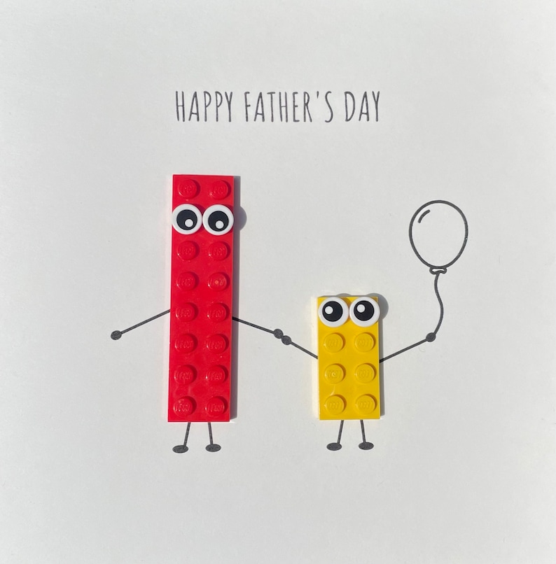 May include: A red and yellow Lego figure card with the text "Happy Father's Day". The red figure is holding a balloon.