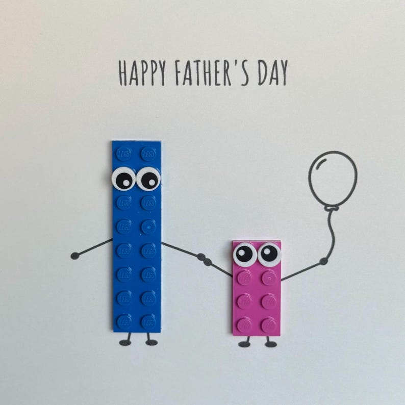 May include: Happy Father's Day card with a blue Lego block with a face and a pink Lego block with a face holding hands. The blue Lego block has a balloon attached to it.
