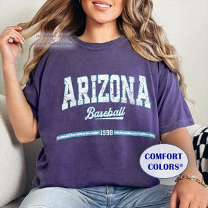 May include: A purple t-shirt with a distressed white graphic that says "Arizona Baseball 1999".