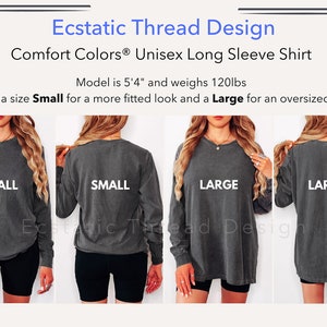 May include: A model wears a charcoal grey long-sleeve shirt in two sizes: Small and Large. The shirt is a unisex style and has a relaxed fit. The model is 5'4" and weighs 120 lbs.