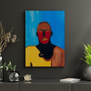 May include: An abstract painting of a person with a red face and yellow shirt against a blue background. The artwork is displayed on a dark gray wall, with decorative vases, a watch, and a potted plant on a gray surface.