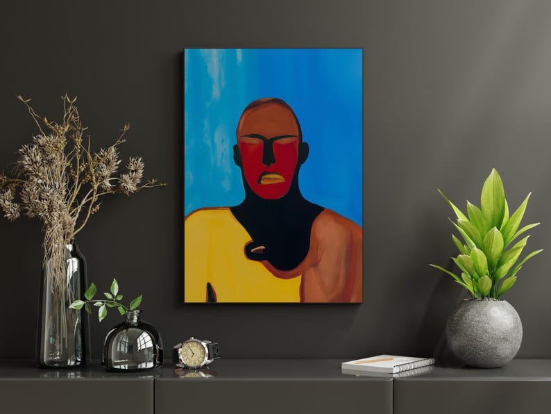 May include: An abstract painting of a person with a red face and yellow shirt against a blue background. The artwork is displayed on a dark gray wall, with decorative vases, a watch, and a potted plant on a gray surface.