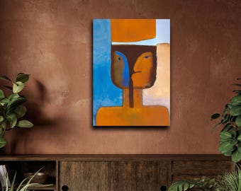 May include: A rectangular wall art print featuring a stylized figure with a split face. One side is blue and the other is orange, separated by a dark brown vertical line. The figure wears a large orange hat against a blue and beige background.