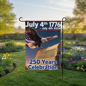 May include: A garden flag with a bald eagle, the American flag, and a scroll. The flag displays the text "July 4th 1776 - July 4th 2026" and "250 Years Celebration". The flag is displayed in a garden.
