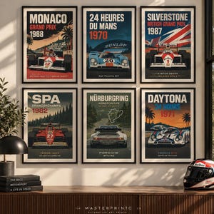 May include: Six framed vertical posters featuring vintage race cars and iconic tracks including Monaco 1988, 24 Heures du Mans 1970, Silverstone 1987, Spa 1982, Nürburgring, and Daytona 1971. Each print displays specific vehicle models and race details.