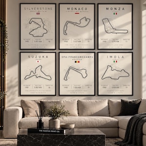 May include: A set of six framed wall art prints featuring black line drawings of Formula One race tracks including Silverstone, Monaco, Monza, Suzuka, Spa-Francorchamps, and Imola. Each print displays the circuit name, country flag, and statistics.