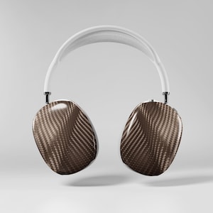 May include: Wireless over-ear headphones with a white headband and dark brown earcups. The earcups have a textured, carbon fiber appearance. The headphones are designed for comfort and high-quality audio.