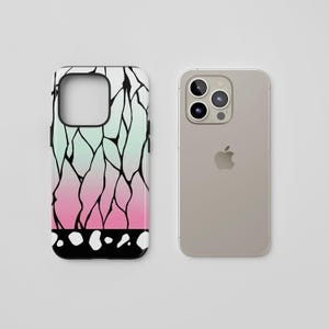 May include: A smartphone case with a colorful design. The case features a gradient of colors, transitioning from light green to pink, with black lines and white dots. Next to it is a silver smartphone.