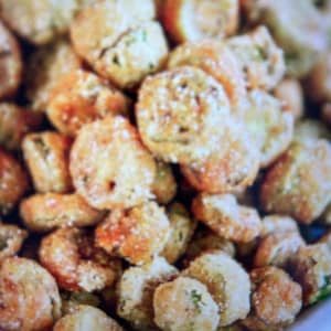 May include: A bowl of fried okra, a Southern food staple, coated in a crispy, golden-brown batter.