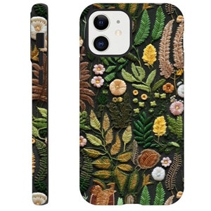 May include: A phone case with a dark green background and a floral pattern embroidered in shades of brown, yellow, and white.