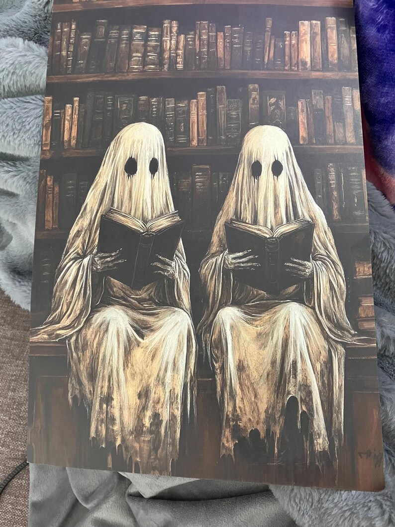 May include: Two white ghostly figures sit in front of a bookshelf filled with books, each holding a book in their hands. The ghosts have black eyes and are wearing white robes.