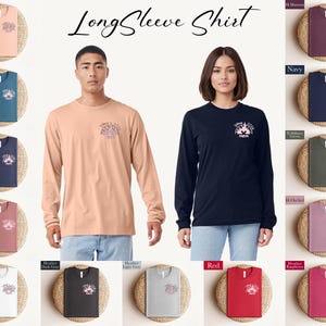 May include: A selection of long-sleeve shirts in various colors, including peach, teal, navy, maroon, white, dark gray, light gray, red, and raspberry. Each shirt features a small graphic on the chest. The image also shows a man and a woman wearing long-sleeve shirts.