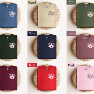 May include: A collection of crewneck sweatshirts in various colors, including indigo blue, sand, military green, forest green, navy, maroon, red, and pink. Each sweatshirt features a graphic of a castle and the word "mom".
