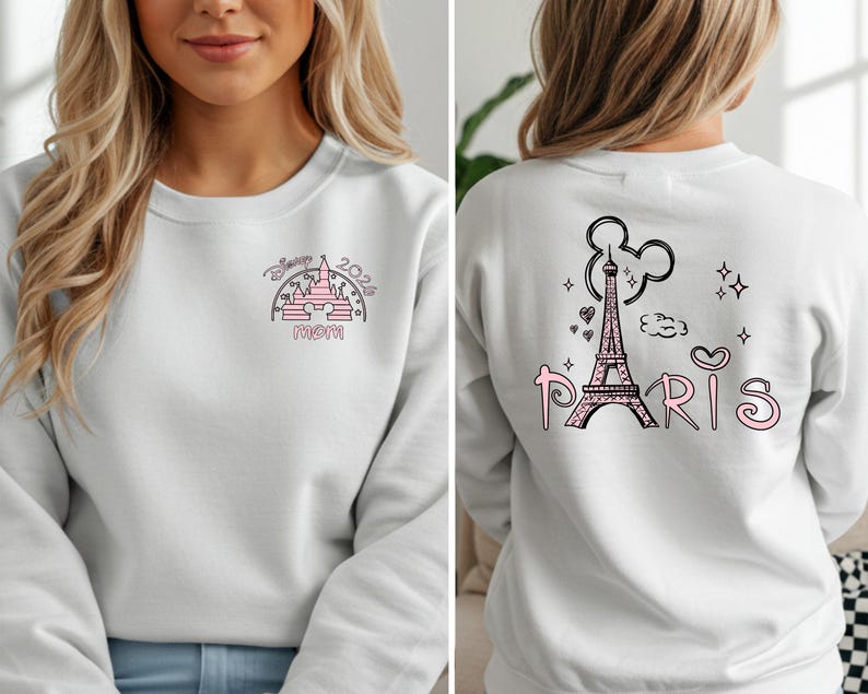 May include: White sweatshirt with a pink and black graphic on the front featuring a castle, the text "Disney 2024 Mom". The back of the sweatshirt has a pink Eiffel Tower graphic with the word "Paris".