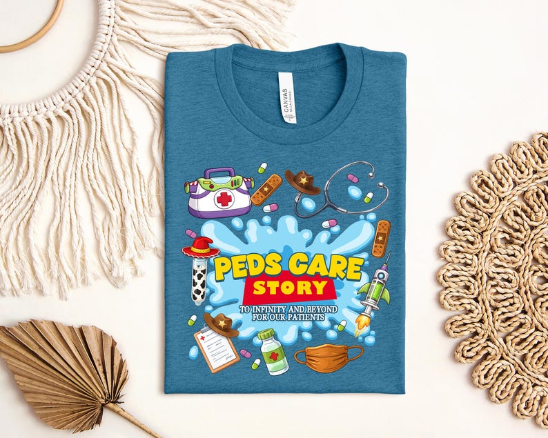 May include: Teal t-shirt with a colorful graphic design. The design includes medical-themed illustrations such as a stethoscope, pills, and a first aid kit. Text on the shirt reads "Peds Care Story" and "To Infinity and Beyond for Our Patients."