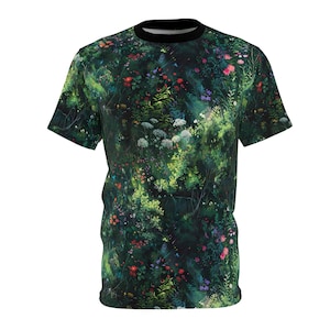 May include: A green t-shirt with a floral print featuring a variety of flowers and plants in shades of pink, red, purple, and white.
