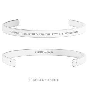 May include: Silver bangle bracelet with the inscription "I can do all things through Christ who strengthens me" on one side and "Philippians 4:13" on the other side. The bracelet has a small cross on each end.