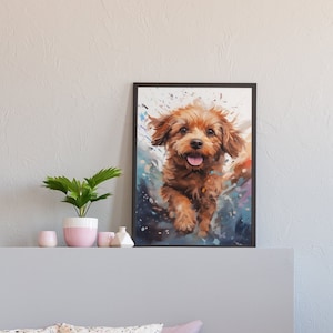 May include: A framed painting of a brown dog with a happy expression, running towards the viewer. The painting is set against a light gray wall, above a gray bed with pink pillows and a pink throw blanket. A pink nightstand with two drawers is on the right side of the image.