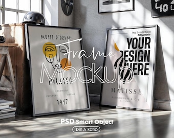 May include: Two framed art prints leaning against a wall. One features a Picasso-style face with the text "MUSEE D'ORSAY PICASSO 1947". The other says "YOUR DESIGN HERE" and "MATISSE". Both have black frames.